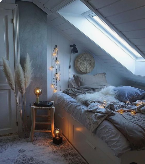 faux fur, pampas grass and lights here and there make the bedroom very welcoming and very cozy