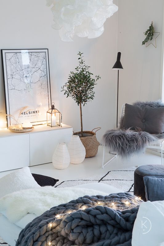 lots of fairy lights here and there and candle lanterns make this Scandinavian living room very cozy
