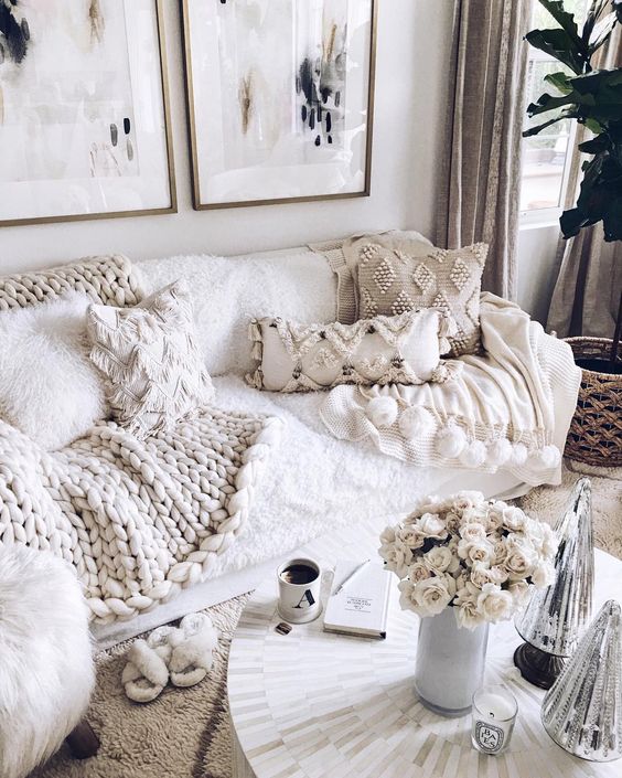 lots of fringe and beaded pillows and a chunky knit blanket make the living room amazingly cozy and wlecoming