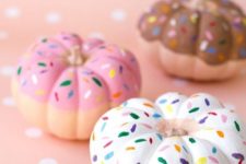 pumpkins painted as pretty donuts are a creative and delicious Thanksgiving decoration to try