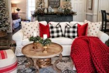 red pillows and a blanket, plaid pillows give the living room a holiday spirit and make it lively