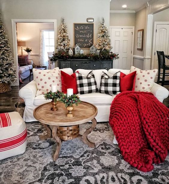 red pillows and a blanket, plaid pillows give the living room a holiday spirit and make it lively