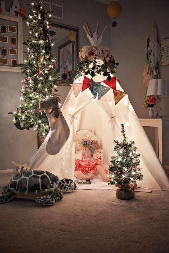 a couple of Christmas trees with lights and beads will create a lovely holiday mood in the kids' room