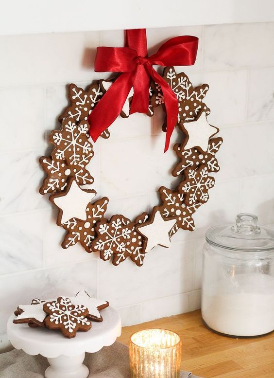 a gorgeous glazed gingerbread star and snowflake Christmas wreath with a red bow is a fantastic idea for the holidays