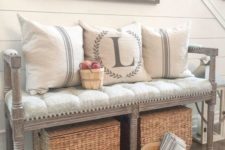 a vintage upholstered farmhouse bench, woven boxes, a sign and some wooden baskets