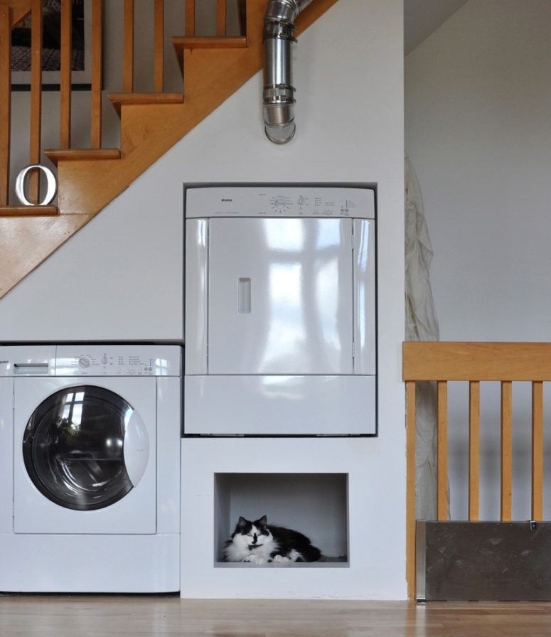 Utilizing residual space under stair to oranize a laundry space  is a great idea. You can also put a pet nook there.