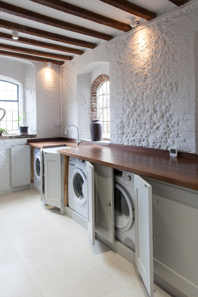 Covered washers and dryers won't spoil farmhouse-style kitchen design.