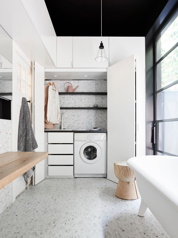 This bathroom and laundry combo is a great example of how you can turn a stylish space into a practical one. (NORTHBOURNE Architecture + Design)