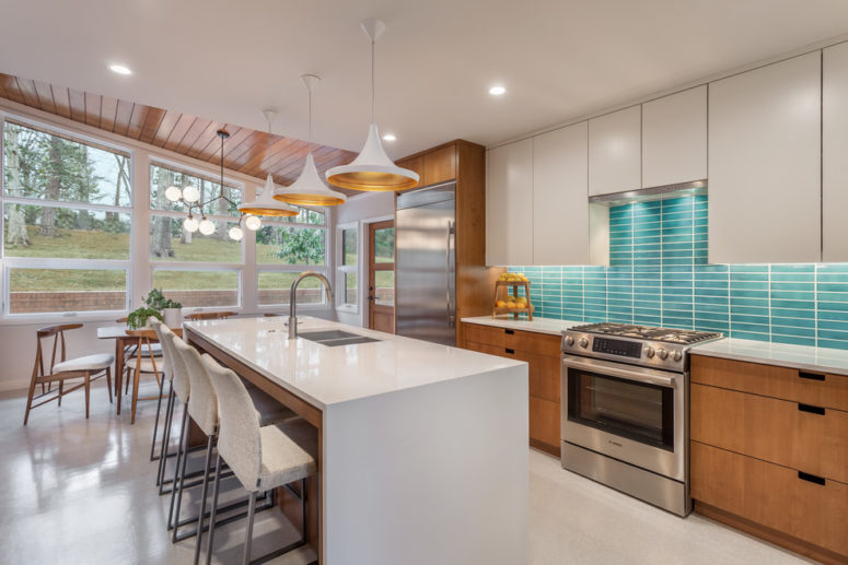 a white and stained mid-century modern kitchen with a white kitchen island and a turquoise tile backsplash  (CarsonSpeer Builders)