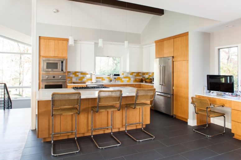 a light yellow mid-century modern kitchen with touches of white and wire stools  (Alair Homes Decatur)