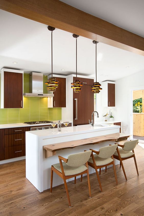 a 60s inspired kitchen with brown cabinets, a white kitchen island and a green tile backsplash
