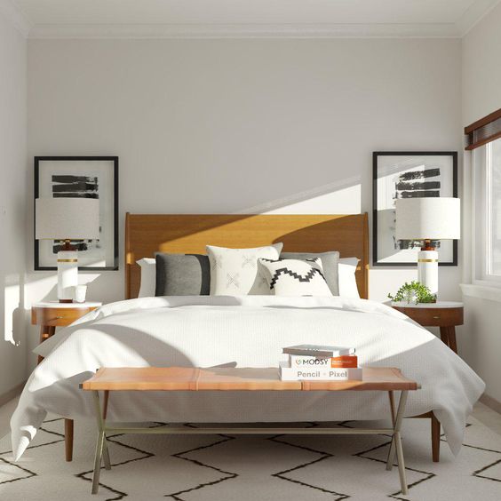 a mid-century minimal bedroom with monochromatic artworks, a leather bed, curved wooden nightstands, a matching bench