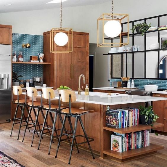 a mid-century modern kitchen with rich-stained cabinets and a kitchen island, a turquoise tile backsplash and geometric pendant lamps