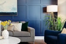a stylish living room with a bright navy panel accent wall