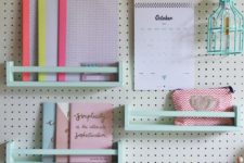 a pegboard with mint mini shelves is a cool idea to style a home office or a kids’ space