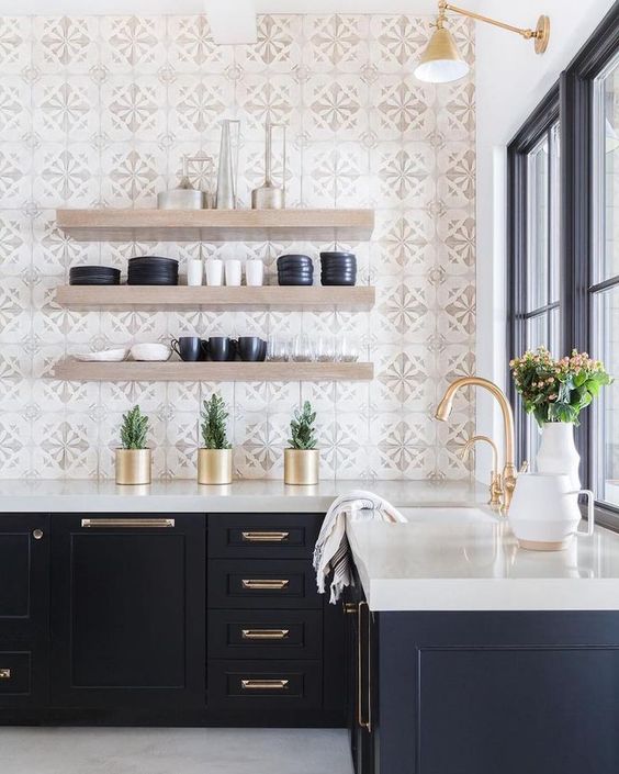an elegant mid-century modern kitchen with mosaic tiles, navy cabinets and a white countertop