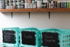 open shelving and blue plastic boxes with chalkboard labels