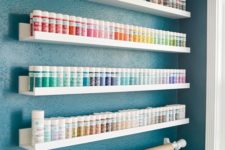 simple IKEA ledges can store all your paints easil and you may organize them by colors