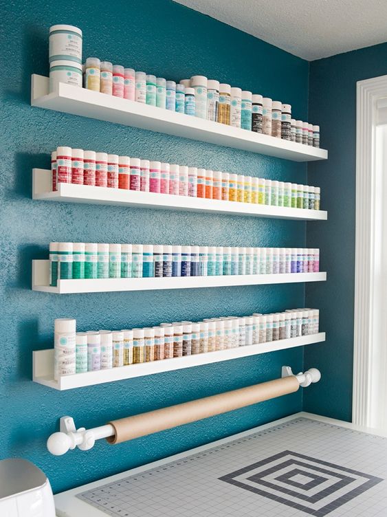 simple IKEA ledges can store all your paints easil and you may organize them by colors