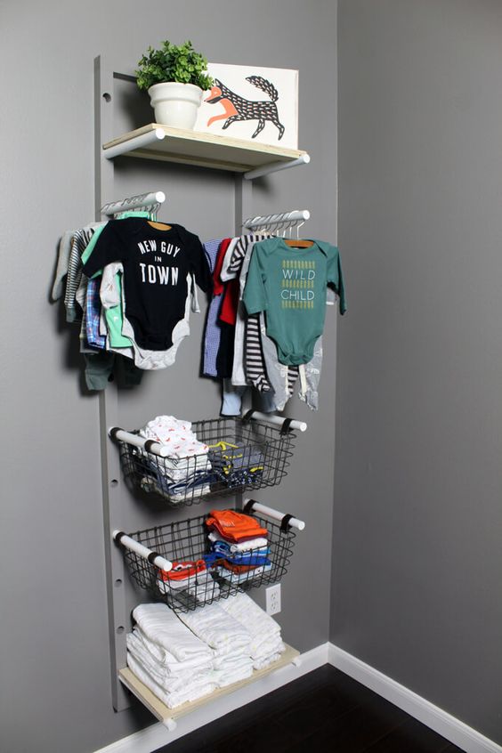 a baby clothes rack with holders, wire baskets and opne shelves is a cool idea to go for