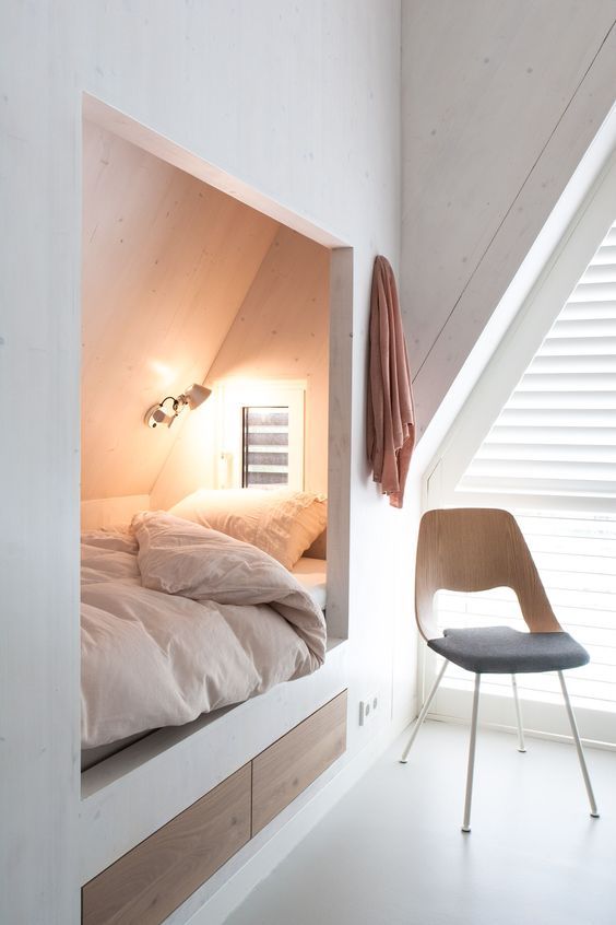 a built-in attic sleeping space with two sleek drawers for storage is amazing for having a cozy nap here