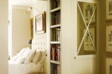 a cool doorway with closed storage cabinets over it and built-in bookshelves right inside the doorway is a very creative idea to declutter the space