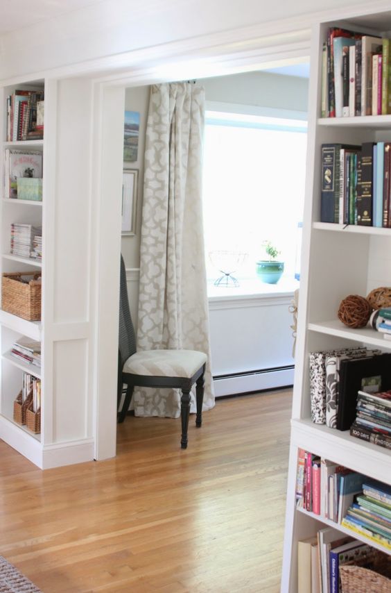 a doorway surrounded with open shelves for book and accessory storage and display is a very cool and fresh idea to rock