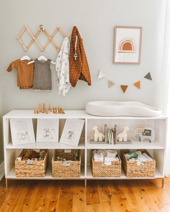 a large changing table with woven boxes and open storage compartments for toys and other stuff