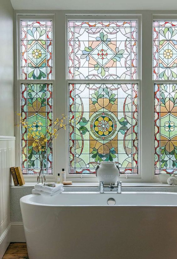 A large stained glass bathroom window is a beautiful vintage inspired feature and a chic statement for a space