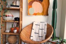 a mid-century modern nook with a wicker arched shelving unit, a round wicker chair, potted plants and a cactus, bold art and rugs