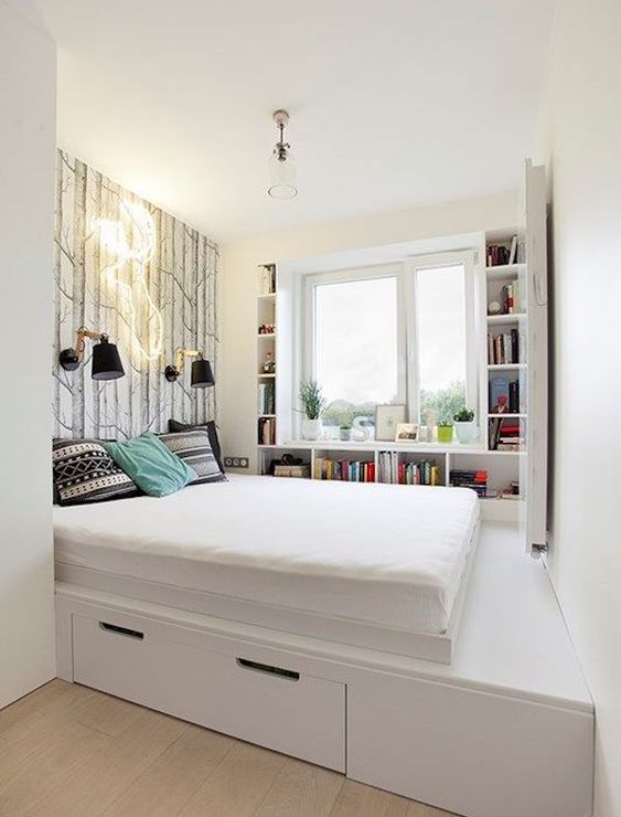 a minimalist white platform bed with a single drawer for storage is a nice solution for a small bedroom