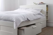 a neutral IKEA Brimnes bed with drawers and a storage headboard is a cool solutioin for a small space