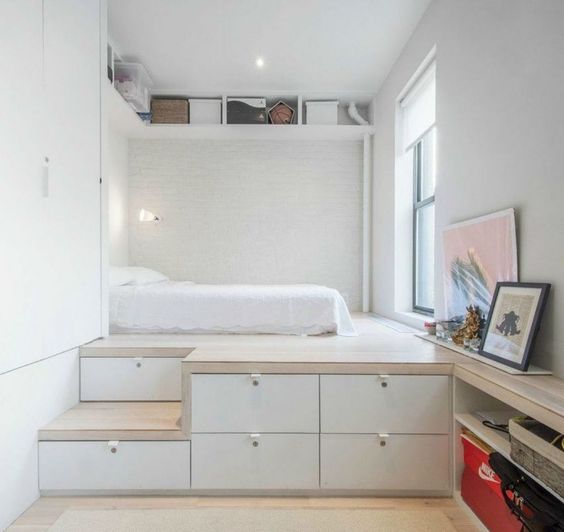 a platform bed with storage drawers is a cool solution for a small bedroom, add an open shelf over it