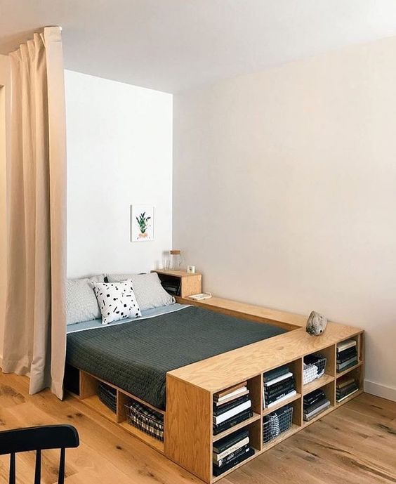 A plywood bed with plenty of storage   open storage compartments and an additional nightstand