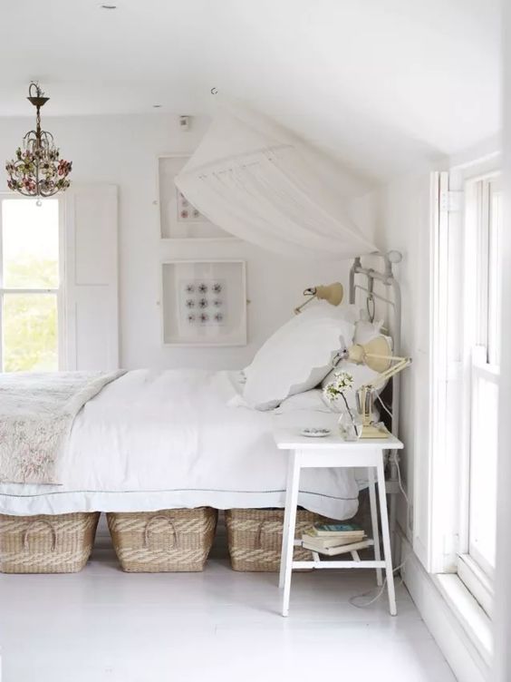 a pretty white bed with some woven baskets for storage is a nice option for those who don't have a ready storage bed