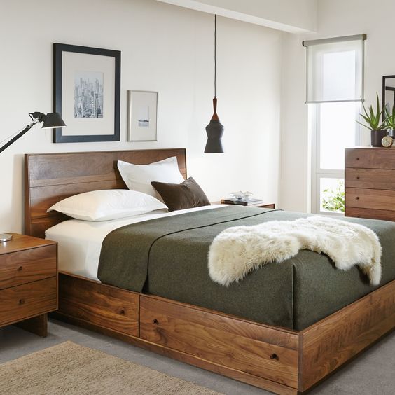 a rich stained bed with drawers with knobs is a very comfortable piece for rocking