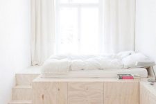 a risen bed with large hidden storage units inside it is a lovely idea for a tiny bedroom