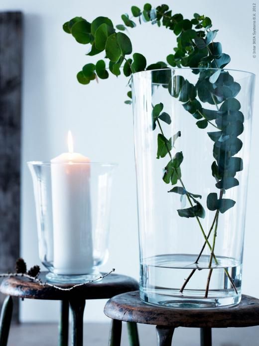 a simple spring decor idea - a glass with a candle and a vase with eucalyptus plus some twigs