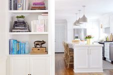 a wide doorway surrounded by open shelves and cabinets is a cool idea to store a lot of things and declutter your spaces