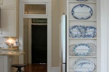 an awkward nook by the doorway used to store decorative plates is a cool idea to show off your collection and use this space, too