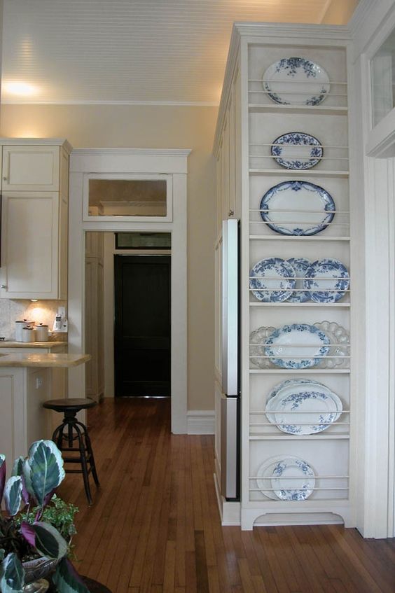 an awkward nook by the doorway used to store decorative plates is a cool idea to show off your collection and use this space, too