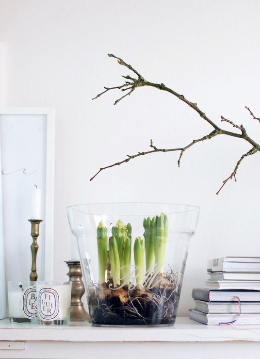 an easy spring decor idea – branches and a glass with bulbs plus candles all around for a Scandinavian feel