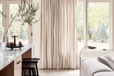 neutral drapes always add an airy feel to the room making it more welcoming and visually larger