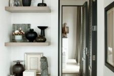 open shelves attached next to the doorway is a great idea to show off beautiful decor and accessories without wasting space