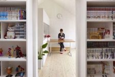 open shelves surrounding the doorway are used for storing kids’ stuff – books, toys and other things in boxes is a smart idea to organize the space