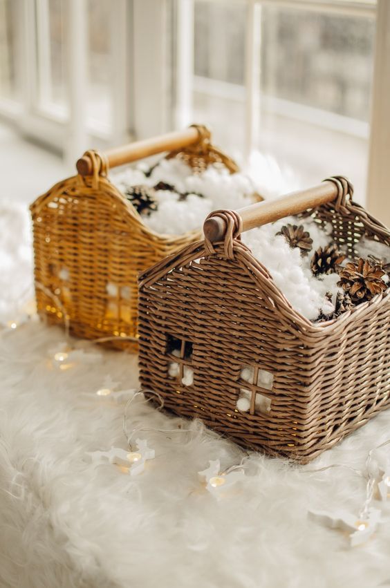 Pretty house inspired baskets with faux snow and pinecones plus lights are a great idea for a rustic space at Christmas