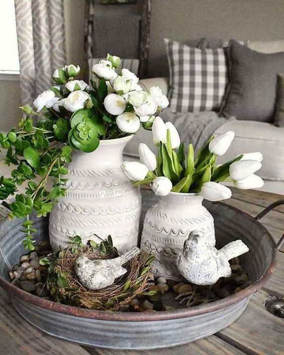 rustic Scandinavian decor with a galvanized tray with greenery and a fake nest with birds, white blooms and greenery