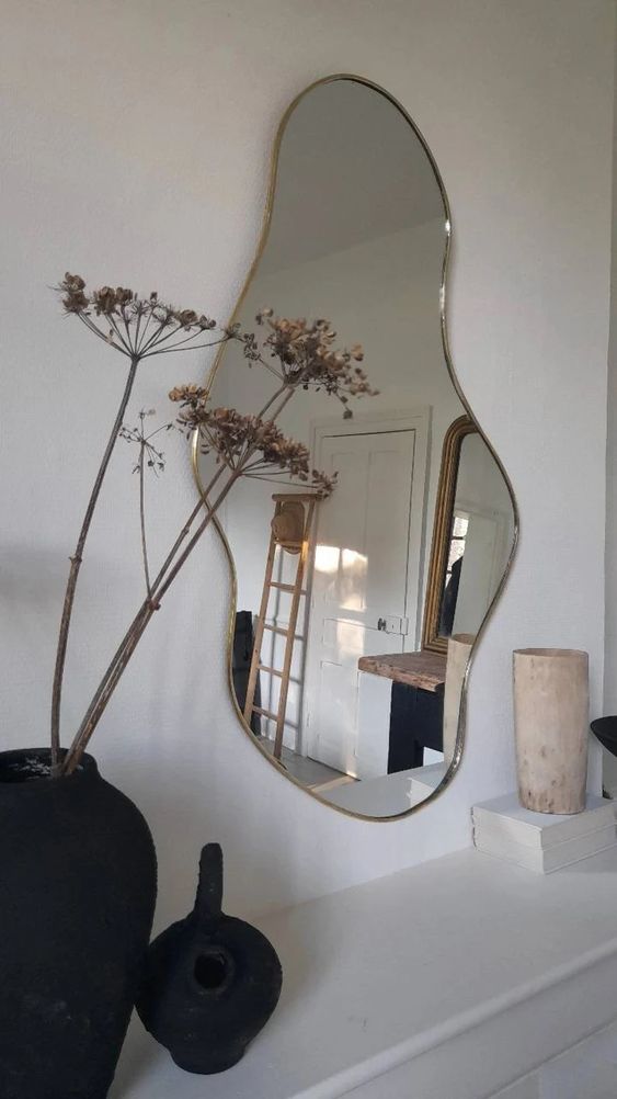 A beautiful organic shaped mirror in a super delicate brass frame is a lovely solution for a Scandinavian space