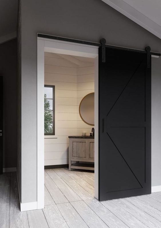 a black and white sliding barn door brings a rustic feel with a modenr touch at the same time