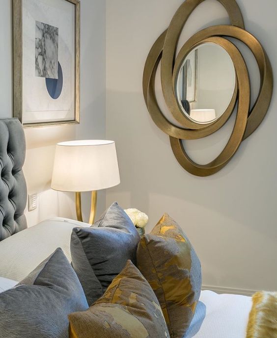 A bold and catchy oval mirror in a unique and catchily shaped frame that looks somewhat sci fi and bold